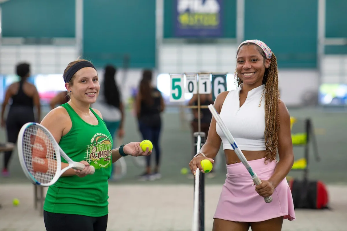 Two women enjoying an adult beginner tennis class at USTA Midwest Tennis Center in Indianapolis
